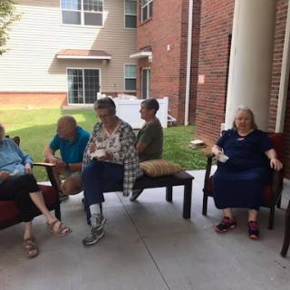 A group of people enjoying a casual moment together outdoors.
