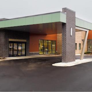 A modern commercial building featuring a distinctive entrance.