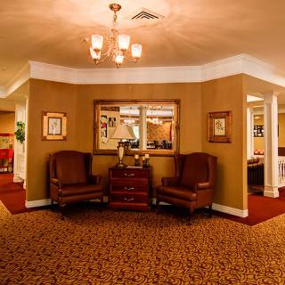 A cozy interior waiting area with comfortable chairs and a decorative setting.