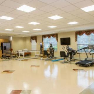 A spacious exercise room equipped with treadmills and other gym equipment.