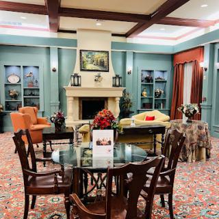 A cozy living room setting featuring a stylish fireplace, comfortable furniture, and a warm inviting decor.