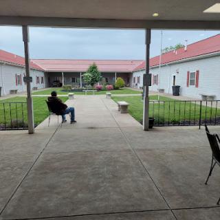 A serene courtyard view with a person sitting and enjoying the open space.