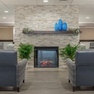 A modern living room with a stylish fireplace and comfortable seating.