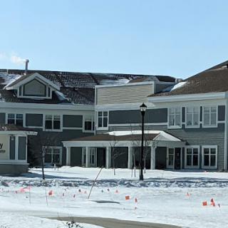 A modern building surrounded by snow in a winter landscape.