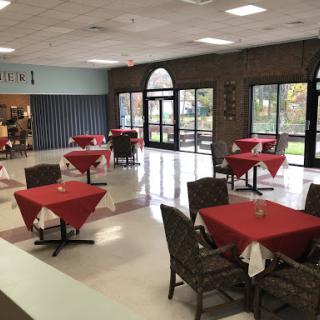 A cozy dining area featuring red-tablecloth-covered tables, ideal for casual meals.