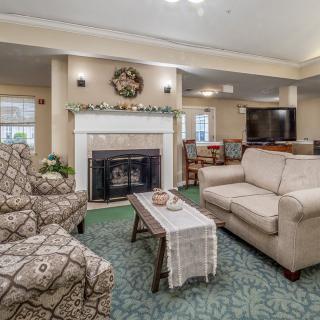 A cozy living room featuring comfortable furniture, a fireplace, and elegant decor.