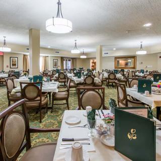 A spacious dining area with neatly arranged tables and chairs, featuring menus on the tables.