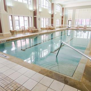 Spacious indoor swimming pool area with ample natural light.