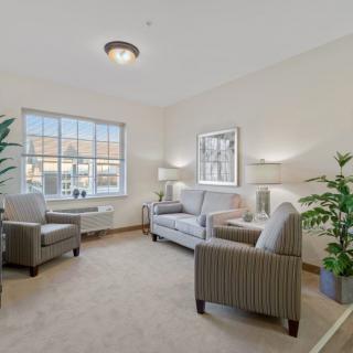 A cozy and bright living room with comfortable seating and natural light.