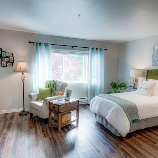 A cozy bedroom with stylish decor and ample natural light.
