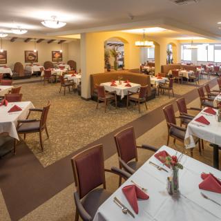 An inviting dining area with neatly arranged tables and chairs, set for service.