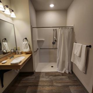 A modern bathroom with a walk-in shower and stylish lighting.
