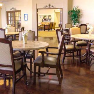 A cozy dining area with tables and chairs arranged neatly.