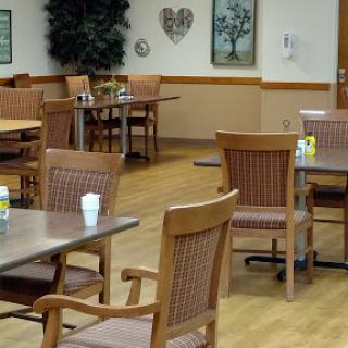 A quiet dining area featuring wooden tables and chairs, creating a welcoming atmosphere.