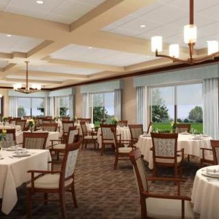 A spacious and elegantly designed restaurant dining area with large windows and neatly arranged tables.