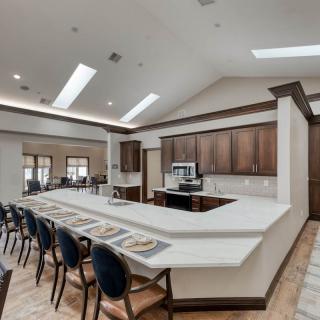 Spacious kitchen and dining area with a long counter and seating.