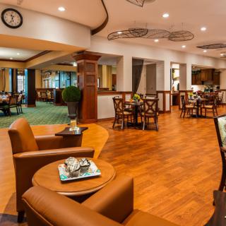 A cozy restaurant interior with warm lighting and comfortable seating arrangements.