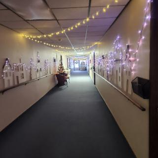 A beautifully decorated hallway illuminated with fairy lights, creating a warm and festive atmosphere.