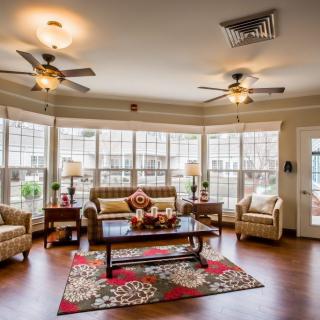A spacious and well-lit living room featuring large windows, comfortable seating, and elegant decor.