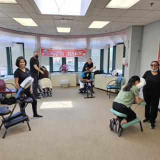A relaxing group massage session taking place in an office setting.