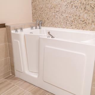A modern walk-in bathtub in a stylish bathroom setting.