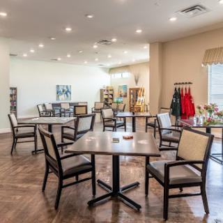 A spacious dining area featuring modern furniture and ample natural light.
