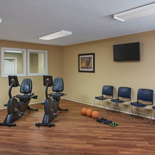 A small fitness room with exercise bikes and other equipment.