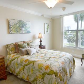 A cozy bedroom with floral bedding and natural light.