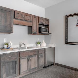 A modern kitchen with wooden cabinets and a white countertop.