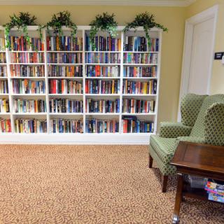 A cozy reading area with a well-stocked bookshelf and comfortable seating.