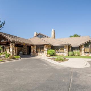 A traditional style house with a stone exterior and well-maintained landscaping.