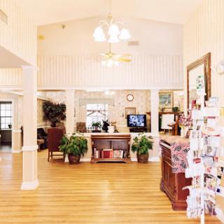 A welcoming reception area with a bright, spacious interior featuring comfortable seating and decorative plants.