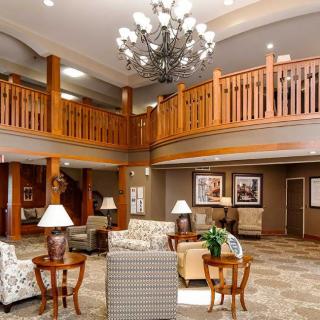 A spacious lobby with a large chandelier and comfortable seating areas.