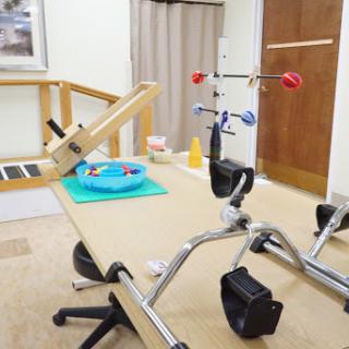 A physical therapy room equipped with various rehabilitation tools and exercise equipment.