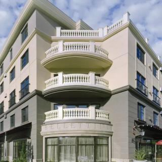 A modern urban building with distinctive balconies and a neutral facade.