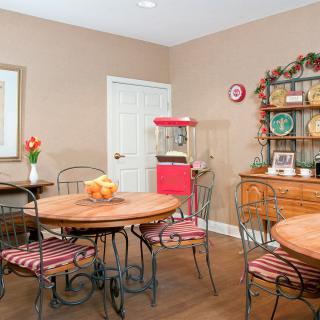 Cozy dining room with rustic furniture and a popcorn machine.