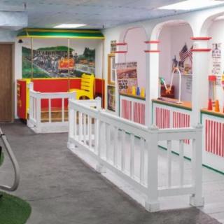 A colorful indoor museum exhibit featuring decorative architecture and art displays.
