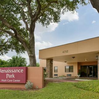 The entrance to Renaissance Park Multi Care Center, surrounded by trees and greenery.