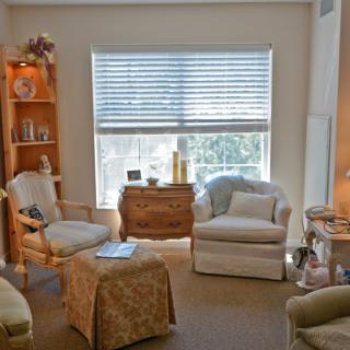 A cozy living room with comfortable seating and ample natural light.