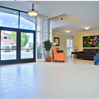A spacious and modern lobby featuring natural light, comfortable seating, and a welcoming atmosphere.