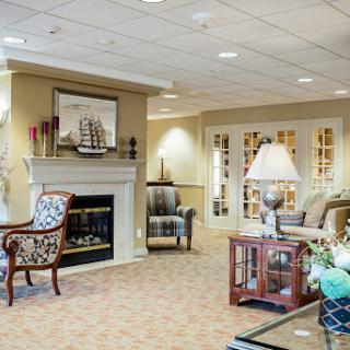 A cozy living room featuring comfortable seating and a warm fireplace.