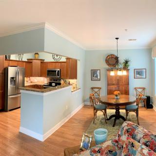 A cozy open-concept living space featuring a kitchen and dining area with stylish wooden furniture and a relaxing atmosphere.