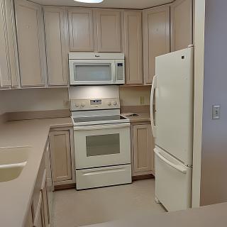 A modern kitchen with white appliances and wooden cabinets.