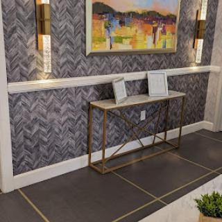 A stylish modern interior featuring a console table, artistic wall decor, and elegant lighting.