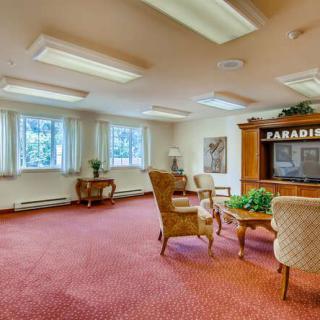 A spacious office room with comfortable seating and large windows.