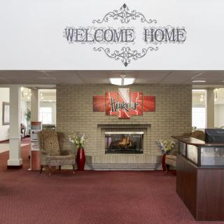 A welcoming lobby with a fireplace, comfortable seating, and decorative elements.