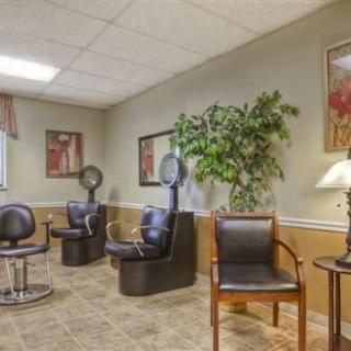 A cozy salon waiting area with seating and hair dryers.