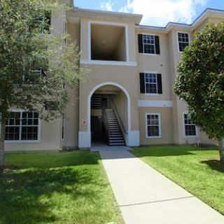 A well-maintained apartment building with landscaped lawns and a welcoming entrance.