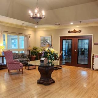 A well-decorated lobby with elegant furnishings and a chandelier.
