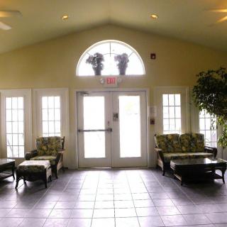 A well-lit lobby or waiting area with comfortable seating and large windows.
